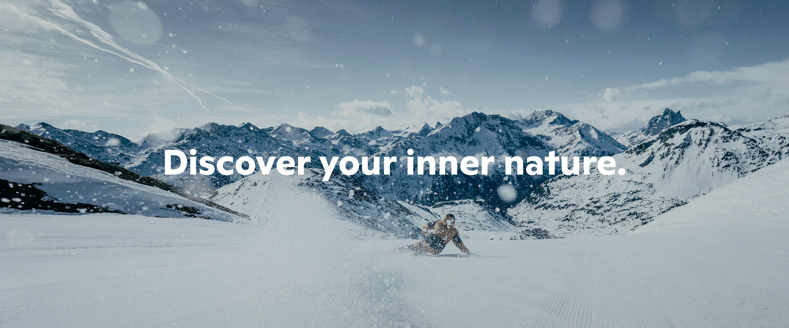 A person skiing down the slope, mountain panorama in the background and the slogan ‘Discover your inner nature’, Schöffel.