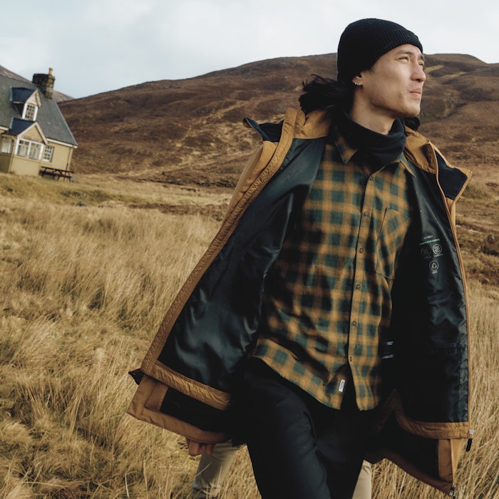 Ein Mann läuft mit einer gelben Wanderjacke, Schöffel.